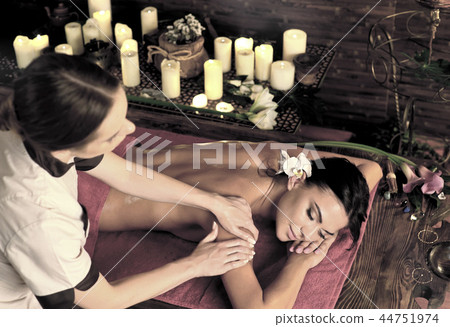 Massage of woman in spa salon. Luxary interior oriental therapy. Massage of woman in spa salon. Luxary interior oriental therapy. 44751974