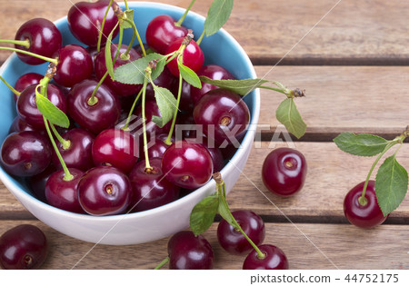 White plate of ripe cherries White plate of ripe cherries 44752175
