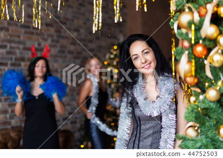 Portrait of attractive brunette woman on New Year's party near decotated Christmas tree 44752503