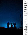 The stars in the night sky and the men sitting 44753154
