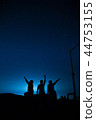 The stars in the night sky and the men sitting 44753155