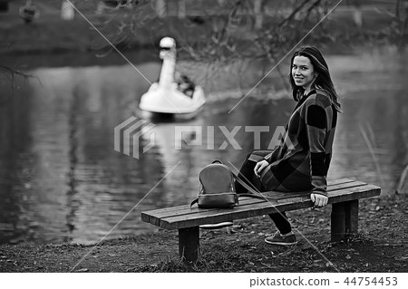 autumn sad girl outdoor / autumn weather, portrait of a young adult girl in a coat in a cage, Scottish style autumn sad girl outdoor / autumn weather, portrait of a young adult girl in a coat in a cage, Scottish style 44754453