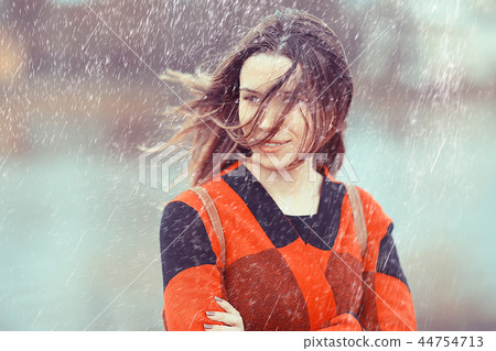rainy weather girl posing fall / raindrops, spray, girl adult on a rain background 44754713