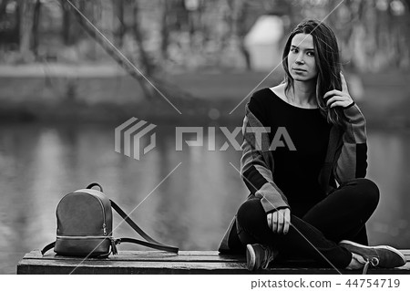 girl in coat outdoor / autumn photo model girl adult posing in park, girl in coat with long hair girl in coat outdoor / autumn photo model girl adult posing in park, girl in coat with long hair 44754719