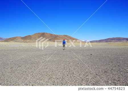 lonely man travels along deserted canyon, desert, lifeless terrain, landscape of highlands lonely man travels along deserted canyon, desert, lifeless terrain, landscape of highlands 44754823
