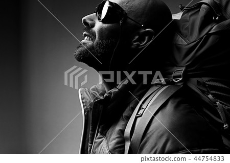 man with backpack, tourist, brutal journey, hike, the concept of active male recreation, portrait of a severe, brutal man, guy preparing equipment for the mountains 44754833