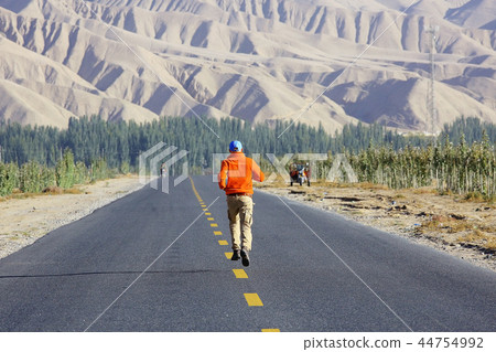 lonely man travels along deserted canyon, desert, lifeless terrain, landscape of highlands 44754992