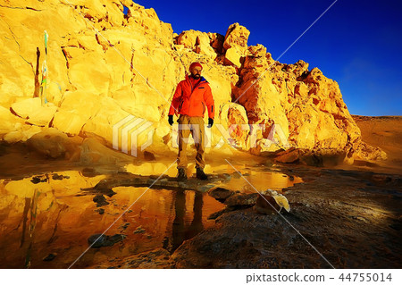 lonely man travels along deserted canyon, desert, lifeless terrain, landscape of highlands 44755014