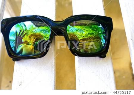 Sun glasses lying on a deckchair 44755117