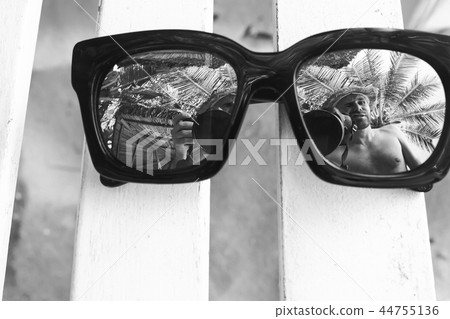 Sun glasses lying on a deckchair 44755136