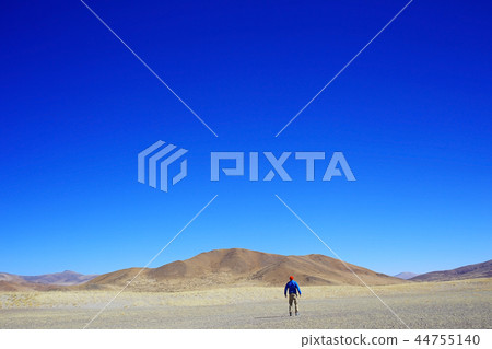 lonely man travels along deserted canyon, desert, lifeless terrain, landscape of highlands 44755140