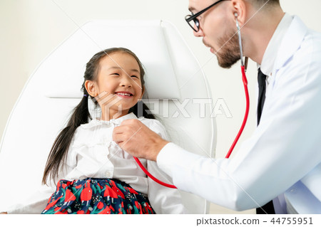 Doctor examining little happy kid in hospital. Doctor examining little happy kid in hospital. 44755951