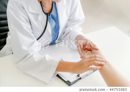 Woman Doctor and Female Patient in Hospital Office Woman Doctor and Female Patient in Hospital Office 44755983