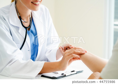 Woman Doctor and Female Patient in Hospital Office Woman Doctor and Female Patient in Hospital Office 44755986