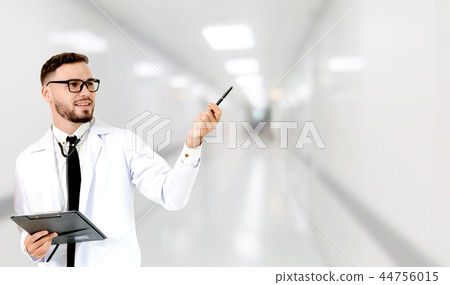 Doctor pointing at empty copy space for your text. 44756015