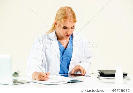 Doctor in hospital working on medical report. 44756075