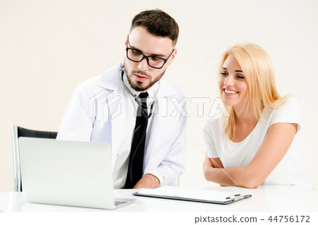 Male Doctor and Female Patient in Hospital Office Male Doctor and Female Patient in Hospital Office 44756172
