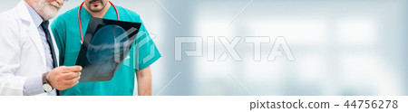 Doctors at hospital working with another doctor. Doctors at hospital working with another doctor. 44756278