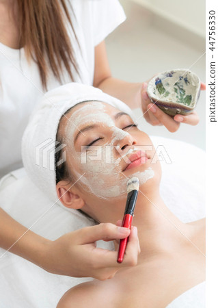 Beautiful woman having a facial treatment at spa. 44756330