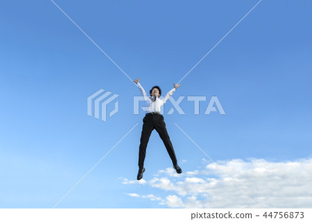 A young businessman in a Y-shirt wearing a shirt while jumping. Success, achievement, achievement, energy, health image 44756873