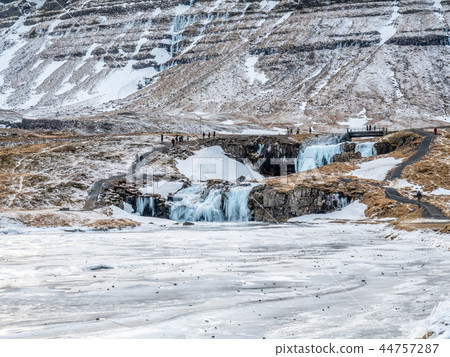 Kirkjufellfoss waterfall in winter, Iceland Kirkjufellfoss waterfall in winter, Iceland 44757287