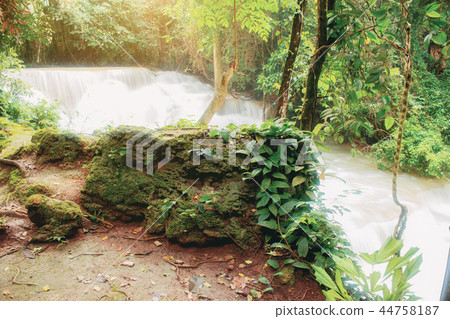 Waterfall and stone at sunlight. Waterfall and stone at sunlight. 44758187