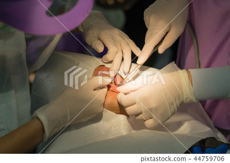 The doctor cleaning the teeth patient The doctor cleaning the teeth patient 44759706