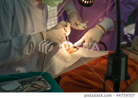 doctor cleaning the teeth patient with ultrasonic doctor cleaning the teeth patient with ultrasonic 44759707