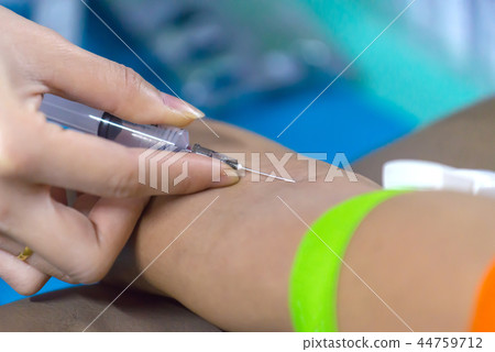 Nurse collecting a blood from patient in hospital 44759712