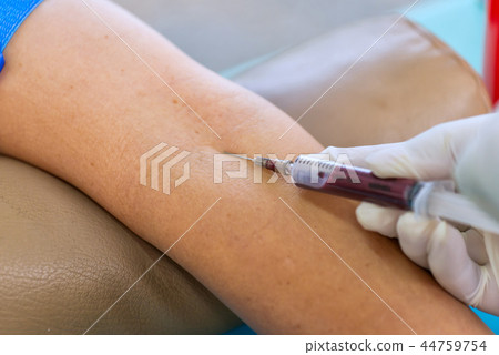 Nurse collecting a blood from patient in hospital 44759754