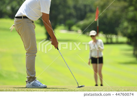 Man and woman playing golf  44760074