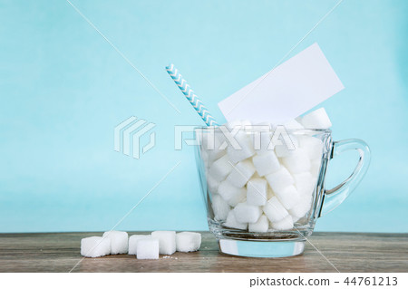 White sugar cube in glass and empty tag label White sugar cube in glass and empty tag label 44761213