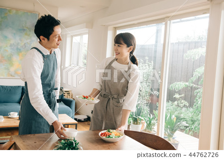 Young couple carrying food to the table Japanese men and women Young couple carrying food to the table Japanese men and women 44762726