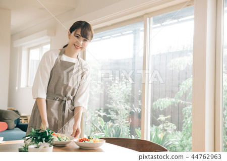 Young housewife carrying meal at the table Japanese woman 44762963