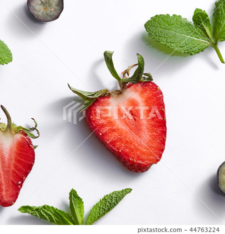 Fruits summer pattern with ripe strawberry, blueberry, leaf of mint on a white background. Fruits summer pattern with ripe strawberry, blueberry, leaf of mint on a white background. 44763224