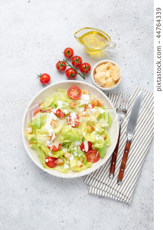 Tasty Caesar salad with chicken on plate, top view Tasty Caesar salad with chicken on plate, top view 44764339