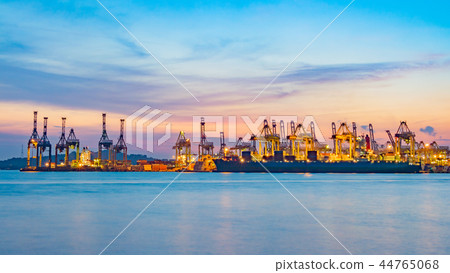 Freighter ship loading cargo at loading dock. Freighter ship loading cargo at loading dock. 44765068
