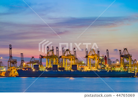 Freighter ship loading cargo at loading dock. 44765069