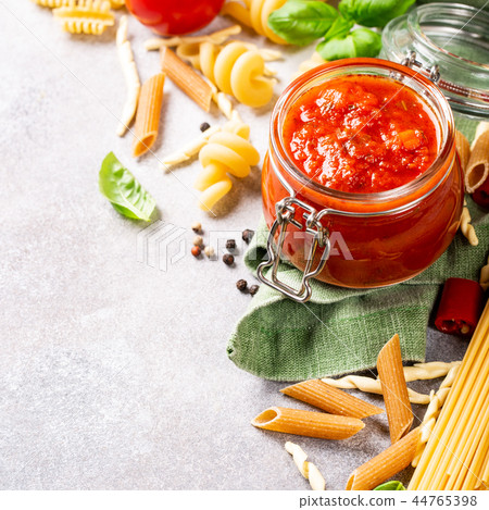 Glass jar with homemade classic spicy tomato pasta or pizza sauce. 44765398