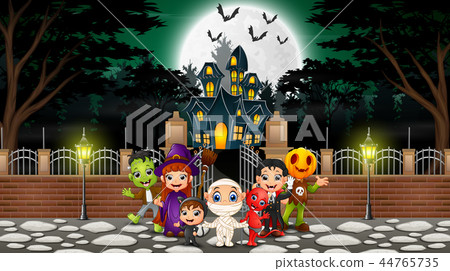 Happy halloween group celebrate in front of haunte Happy halloween group celebrate in front of haunte 44765735