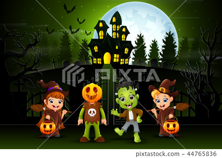 Happy halloween kids outdoors with haunted house b 44765836