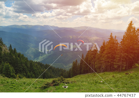 Paraglider taking off in front of mountain scenery 44767437