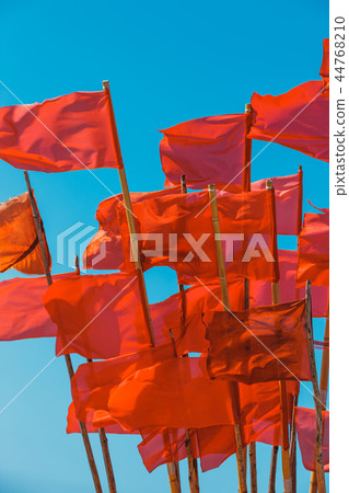 Fishing boat and red flags flying in wind 44768210