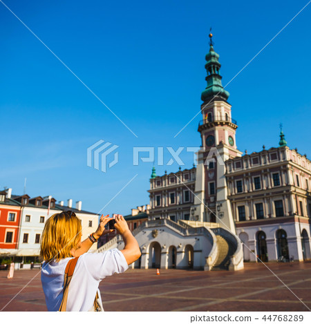 Woman photographing Old Town of Zamosc, Poland Woman photographing Old Town of Zamosc, Poland 44768289
