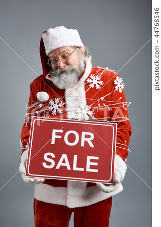 Unhappy tied up Santa Claus holding banner for sale Unhappy tied up Santa Claus holding banner for sale 44768546