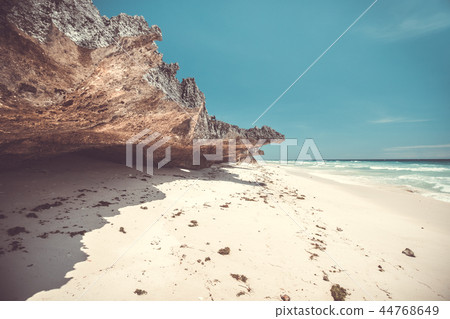 White sand beach next to the sheer rock. Indonesia White sand beach next to the sheer rock. Indonesia 44768649