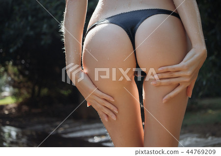 Crop woman walking near outdoor shower 44769209