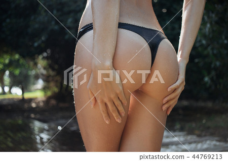 Crop woman walking near outdoor shower 44769213