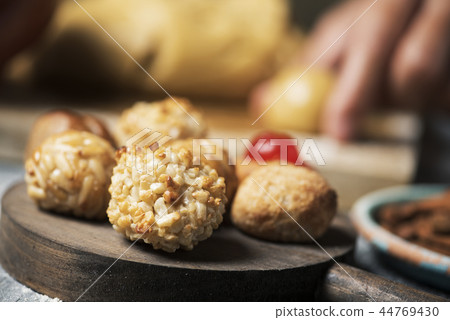 man preparing panellets, typical of Catalonia man preparing panellets, typical of Catalonia 44769430