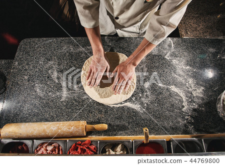 Granting a dough form. Dough for pizza 44769800